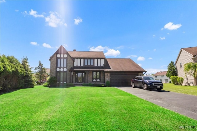 24 Bluejay Cir, Lancaster, NY 14086 - view of front facade with a front yard, a garage, asphalt driveway, and brick siding