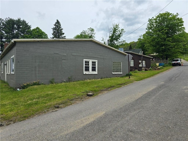 1077 Looker Mtn, Otto Twp, PA 16745 - view of side of home featuring concrete block siding and a lawn