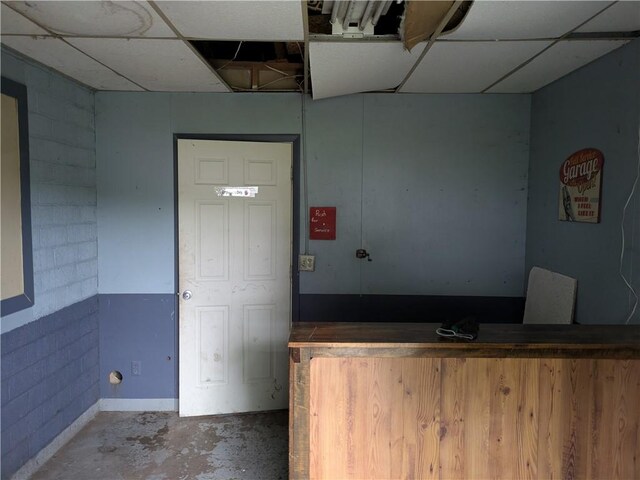 1077 Looker Mtn, Otto Twp, PA 16745 - interior space featuring unfinished concrete flooring and a drop ceiling