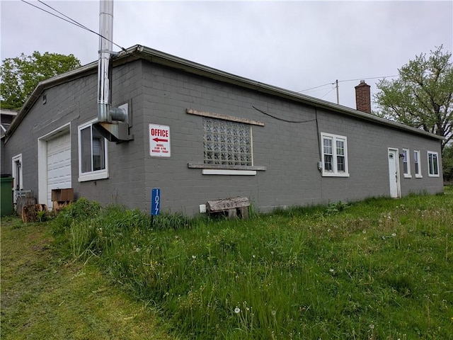 1077 Looker Mtn, Otto Twp, PA 16745 - view of side of home with a chimney and concrete block siding