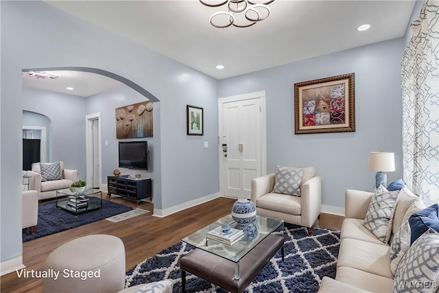 405 W Ferry St, Buffalo, NY 14213 - living room featuring arched walkways, wood finished floors, and baseboards