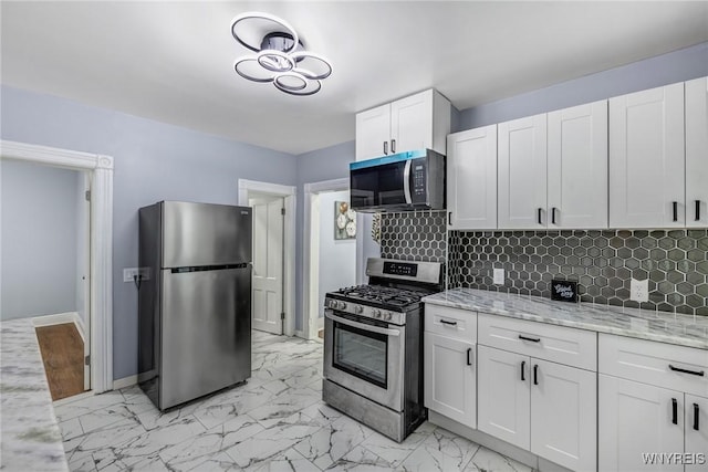 405 W Ferry St, Buffalo, NY 14213 - kitchen featuring appliances with stainless steel finishes, baseboards, light marble finish flooring, and backsplash