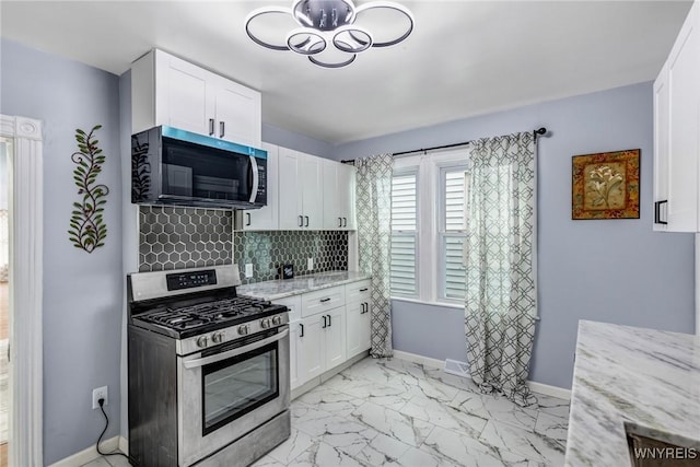 405 W Ferry St, Buffalo, NY 14213 - kitchen with stainless steel gas range, white cabinets, light stone countertops, decorative backsplash, and light marble finish flooring
