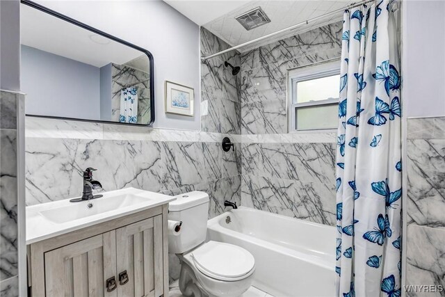 405 W Ferry St, Buffalo, NY 14213 - full bath with shower / bathtub combination with curtain, toilet, tile walls, and vanity