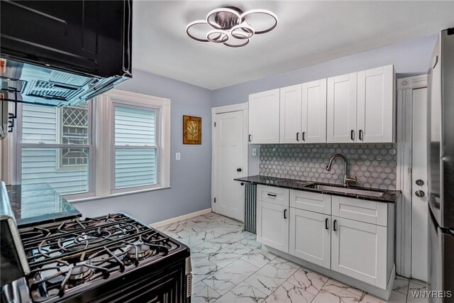 405 W Ferry St, Buffalo, NY 14213 - kitchen featuring light marble finish floors, a sink, decorative backsplash, and white cabinets