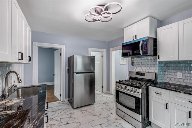 405 W Ferry St, Buffalo, NY 14213 - kitchen featuring appliances with stainless steel finishes, a sink, tasteful backsplash, and dark stone counters