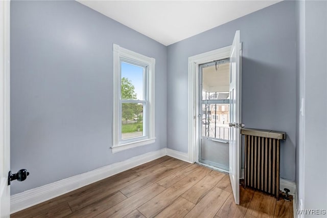 405 W Ferry St, Buffalo, NY 14213 - unfurnished room with radiator heating unit, wood finished floors, and baseboards