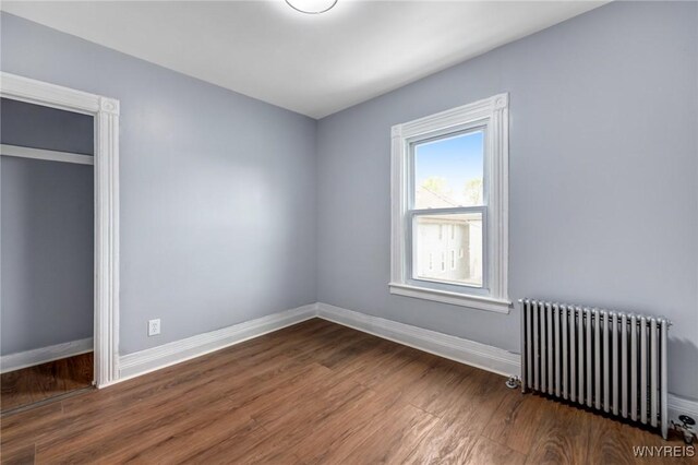 405 W Ferry St, Buffalo, NY 14213 - unfurnished bedroom with radiator heating unit, wood finished floors, and baseboards