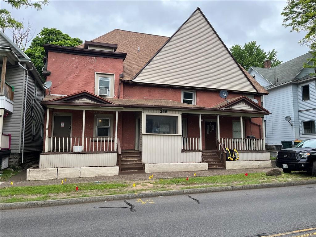 244 Driving Park Ave, Rochester, NY 14613 - view of front of property featuring covered porch, cooling unit, brick siding, and roof with shingles