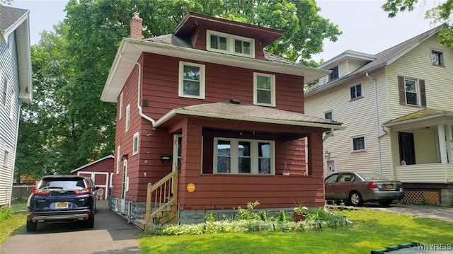 58 Nellis Park, Rochester, NY 14608 - traditional style home with a chimney, a front yard, a shingled roof, and a detached garage
