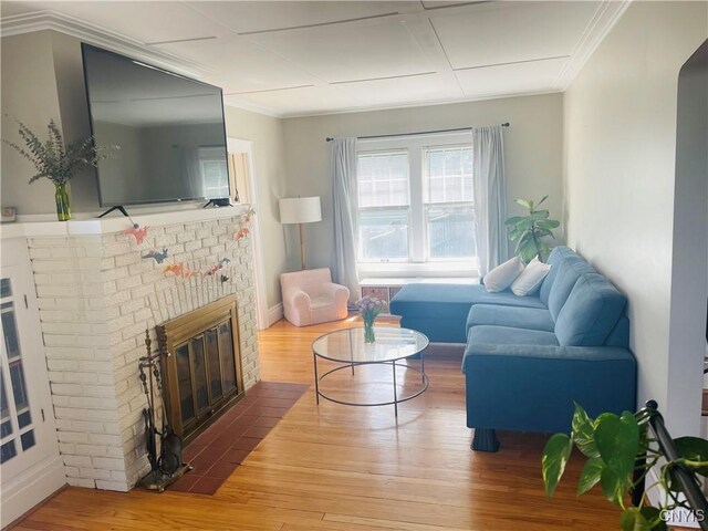 626 Roberts Ave, Syracuse, NY 13207 - living room featuring hardwood / wood-style floors, a fireplace, ornamental molding, and baseboards
