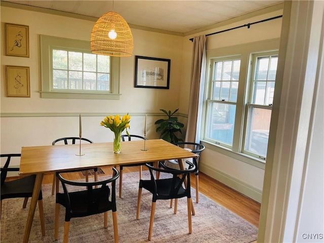 626 Roberts Ave, Syracuse, NY 13207 - dining space with healthy amount of natural light, wood finished floors, and baseboards