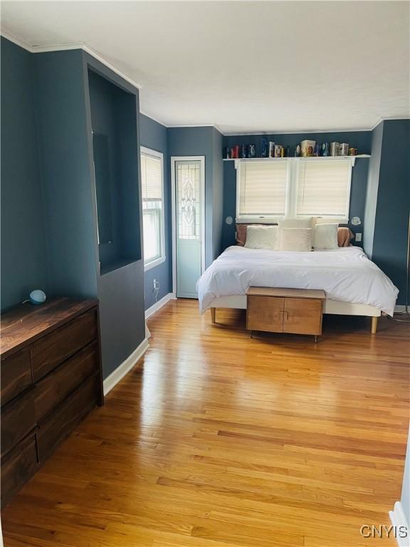 626 Roberts Ave, Syracuse, NY 13207 - bedroom with light wood finished floors, baseboards, and crown molding