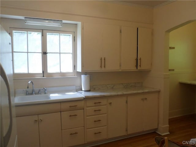 626 Roberts Ave, Syracuse, NY 13207 - kitchen featuring crown molding, light countertops, wood finished floors, a sink, and freestanding refrigerator