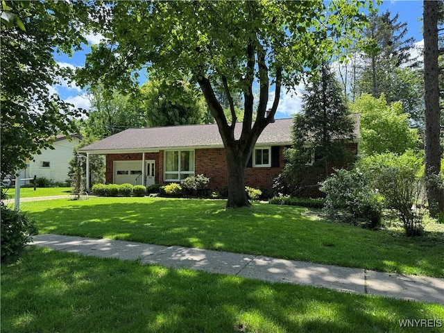 725 Warren Dr, Aurora, NY 14052 - single story home with brick siding, a garage, and a front yard