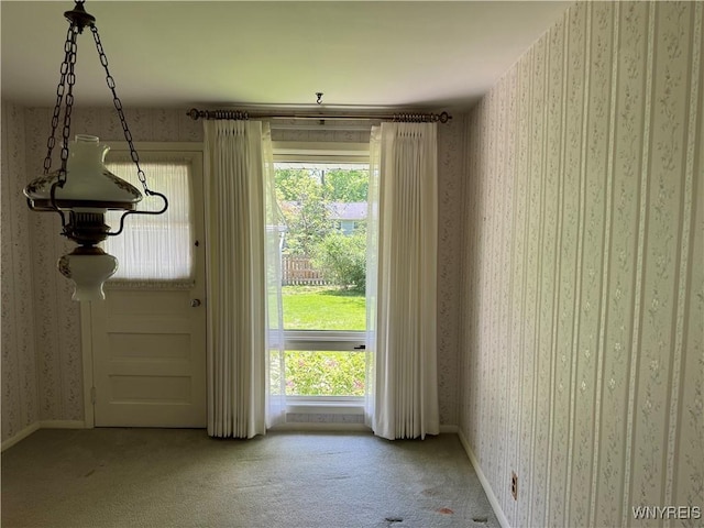 725 Warren Dr, Aurora, NY 14052 - unfurnished dining area featuring wallpapered walls, carpet, healthy amount of natural light, and baseboards