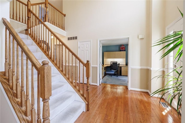 56 Edenfield Rd, Penfield, NY 14526 - stairs with a high ceiling, hardwood / wood-style flooring, and baseboards