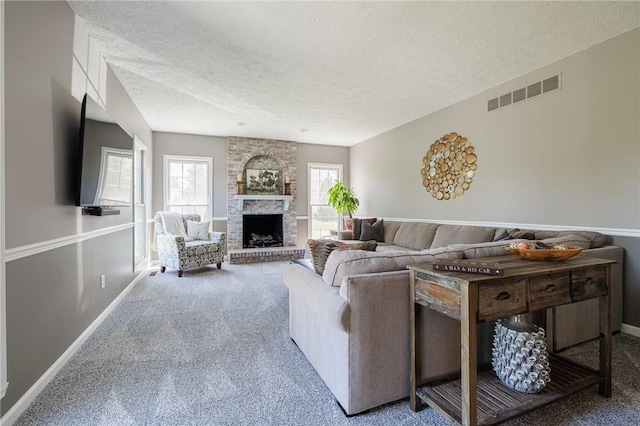 56 Edenfield Rd, Penfield, NY 14526 - living room with carpet floors, a textured ceiling, baseboards, and a large fireplace