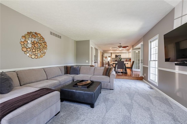 56 Edenfield Rd, Penfield, NY 14526 - living area with ceiling fan, light carpet, and baseboards
