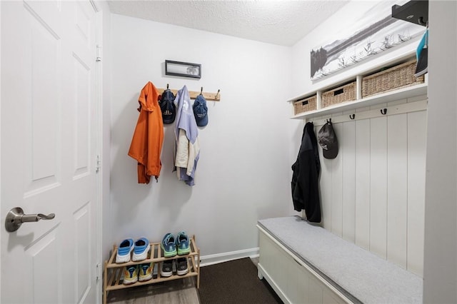 56 Edenfield Rd, Penfield, NY 14526 - mudroom featuring baseboards and a textured ceiling