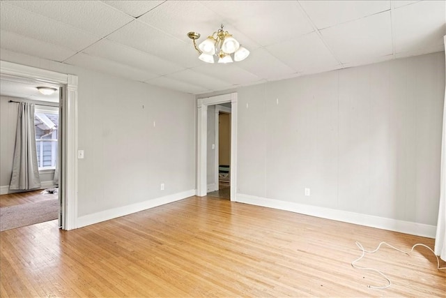 262 Pearl St, Rochester, NY 14607 - unfurnished room featuring light wood-type flooring, a chandelier, and baseboards