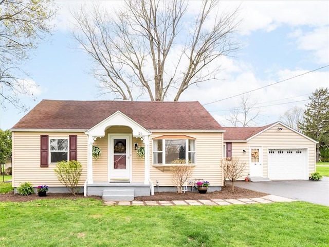 26 Groveland, Geneseo, NY 14454 - view of front of property featuring driveway, a front yard, a garage, and a shingled roof