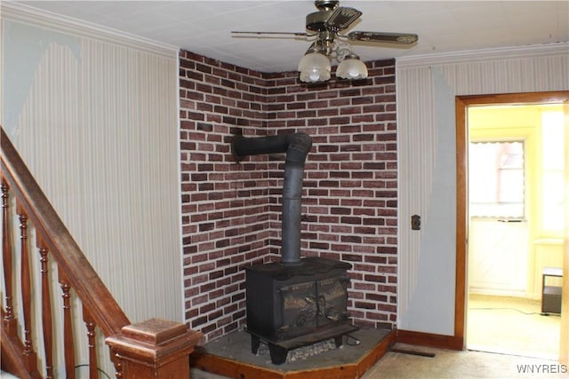 116 Merden St, Salamanca-City, NY 14779 - detailed view of a wood stove, ornamental molding, ceiling fan, baseboards, and wallpapered walls