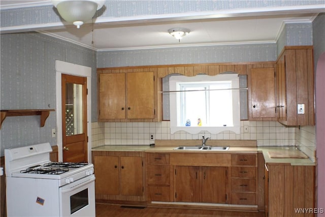 116 Merden St, Salamanca-City, NY 14779 - kitchen with gas range gas stove, wallpapered walls, a sink, ornamental molding, and brown cabinetry
