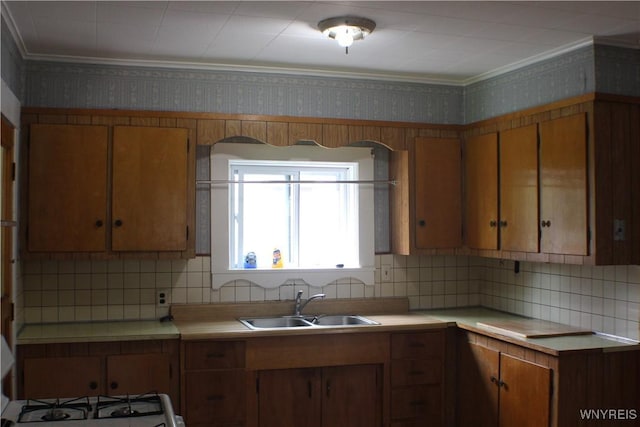 116 Merden St, Salamanca-City, NY 14779 - kitchen featuring a sink, wallpapered walls, light countertops, brown cabinetry, and decorative backsplash