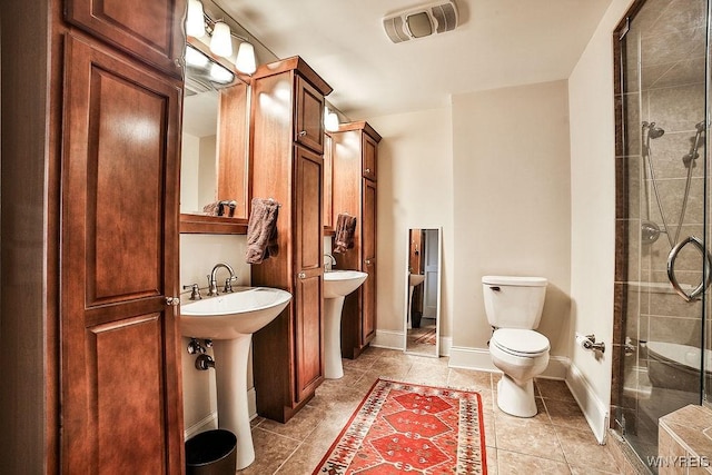 132 Lakefront Blvd Unit 204, Buffalo, NY 14202 - full bathroom featuring toilet, a stall shower, tile patterned flooring, and a sink