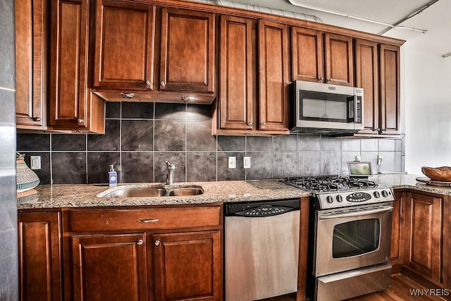 132 Lakefront Blvd Unit 204, Buffalo, NY 14202 - kitchen featuring stainless steel appliances, a sink, tasteful backsplash, and light stone counters