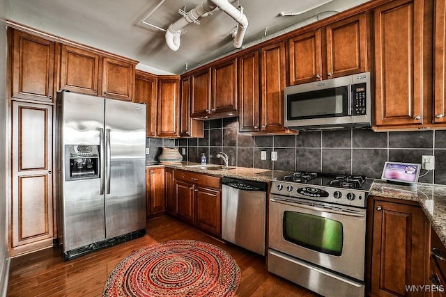 132 Lakefront Blvd Unit 204, Buffalo, NY 14202 - kitchen with stainless steel appliances, dark wood-type flooring, decorative backsplash, and stone counters
