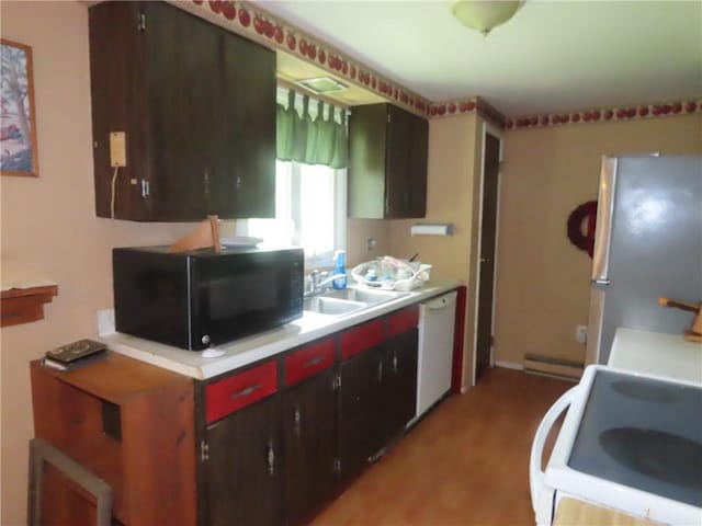 5015 S Centenary Rd, Sodus, NY 14505 - kitchen with white appliances, a sink, light wood-type flooring, light countertops, and baseboard heating