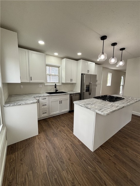3758 Lake Rd N, Clarkson, NY 14420 - kitchen with appliances with stainless steel finishes, a sink, a center island, dark wood-type flooring, and white cabinetry