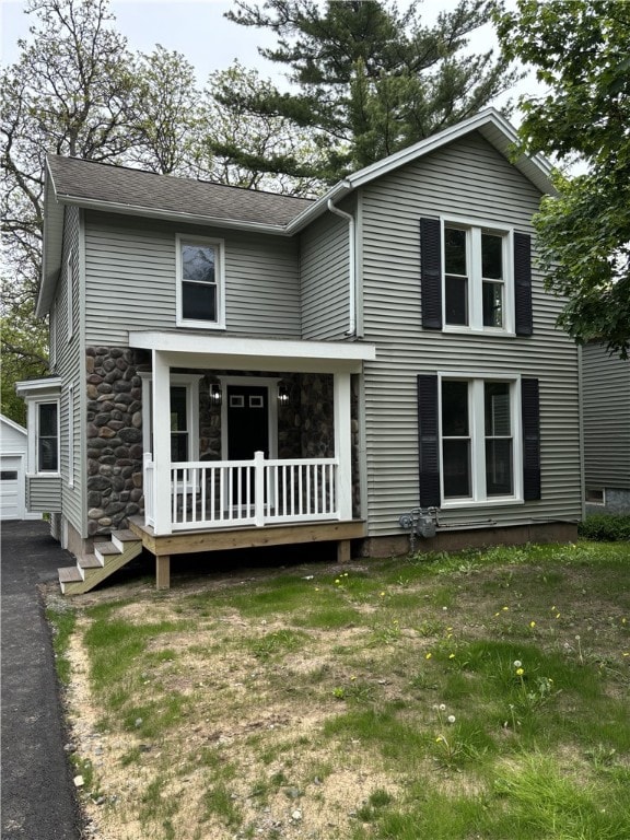 3758 Lake Rd N, Clarkson, NY 14420 - view of front facade featuring stone siding, an outbuilding, and covered porch