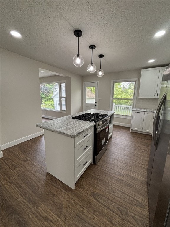 3758 Lake Rd N, Clarkson, NY 14420 - kitchen with stainless steel appliances, white cabinetry, healthy amount of natural light, light stone counters, and a textured ceiling