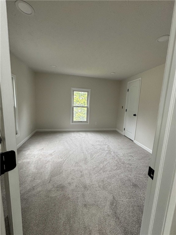 3758 Lake Rd N, Clarkson, NY 14420 - spare room with carpet floors, baseboards, and a textured ceiling