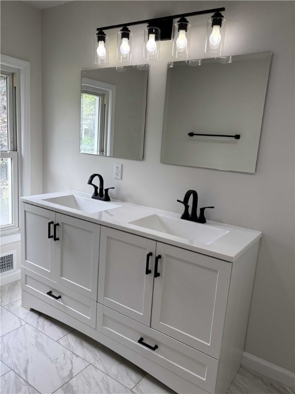 3758 Lake Rd N, Clarkson, NY 14420 - full bath with marble finish flooring, double vanity, plenty of natural light, and baseboards