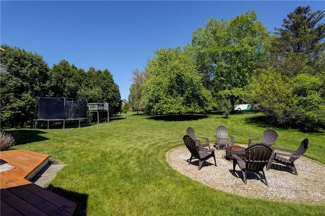 16 Canterbury Trl, Penfield, NY 14450 - view of grassy yard featuring an outdoor fire pit and a trampoline