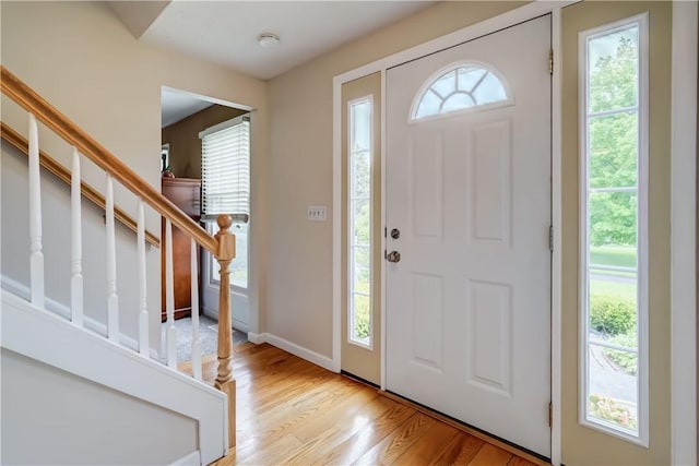 16 Canterbury Trl, Penfield, NY 14450 - entrance foyer with light wood finished floors, stairway, and baseboards