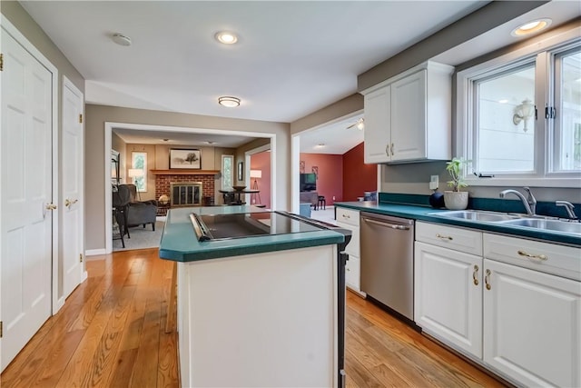 16 Canterbury Trl, Penfield, NY 14450 - kitchen with stainless steel dishwasher, a sink, a center island, white cabinetry, and dark countertops