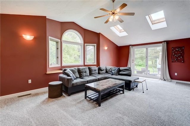 16 Canterbury Trl, Penfield, NY 14450 - carpeted living room with a skylight, vaulted ceiling, a ceiling fan, and baseboards