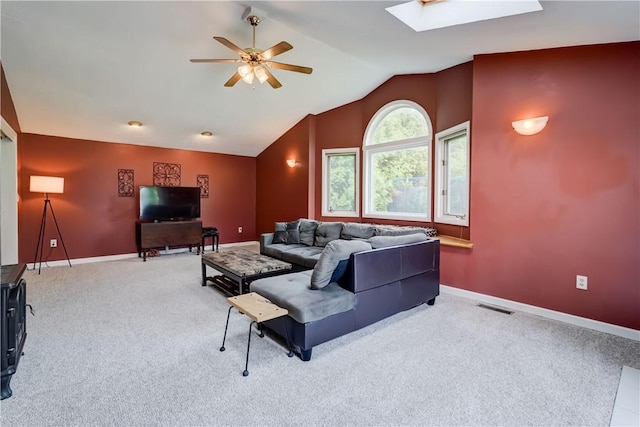 16 Canterbury Trl, Penfield, NY 14450 - carpeted living room with ceiling fan, a skylight, lofted ceiling, and baseboards