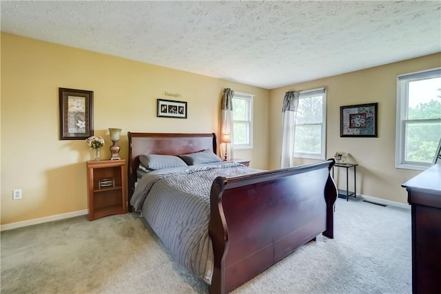 16 Canterbury Trl, Penfield, NY 14450 - bedroom with light carpet, a textured ceiling, baseboards, and multiple windows