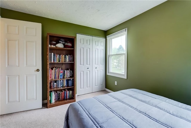 16 Canterbury Trl, Penfield, NY 14450 - carpeted bedroom featuring a closet, a textured ceiling, and baseboards