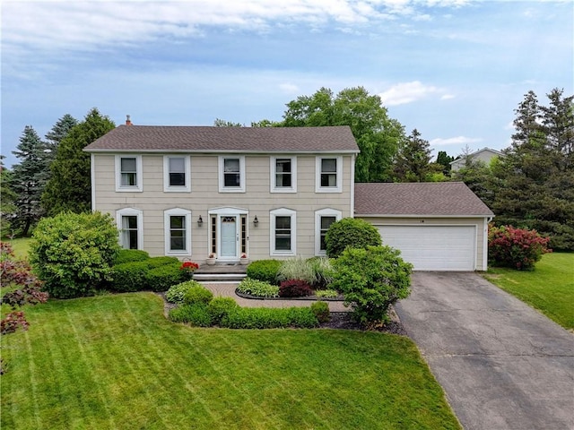 16 Canterbury Trl, Penfield, NY 14450 - colonial home featuring a front lawn, driveway, an attached garage, and roof with shingles