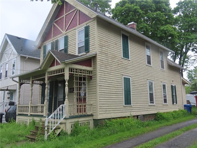 11 Cortland St, Geneva-City, NY 14456 - view of front of home with a porch and a chimney