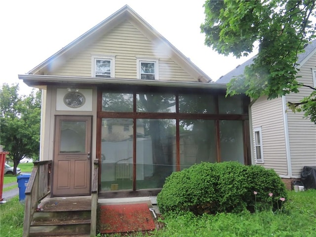11 Cortland St, Geneva-City, NY 14456 - rear view of house featuring a sunroom