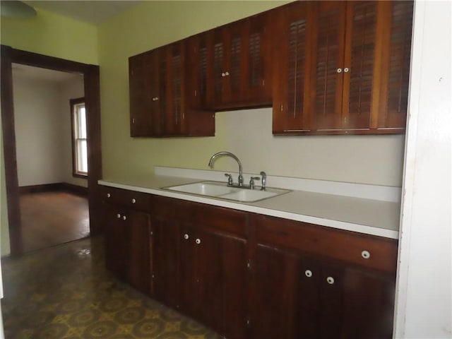 11 Cortland St, Geneva-City, NY 14456 - kitchen with a sink, light countertops, and dark brown cabinets
