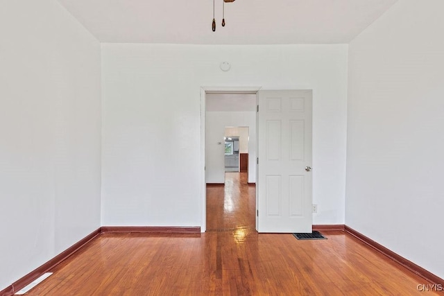 410 John St, Syracuse, NY 13208 - unfurnished room featuring wood finished floors and baseboards